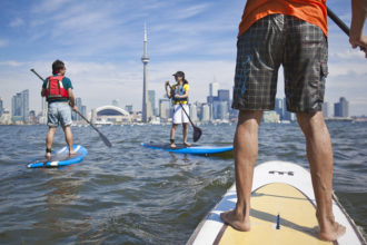 Students out on a SUP board at Harbourfront Canoe & Kayak Center Photograph by Goh Iromoto