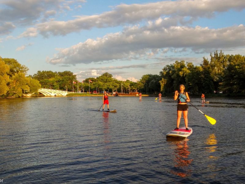 People going out on a stand up paddleboard after renting them from Harbourfront Canoe &amp; Kayak Center